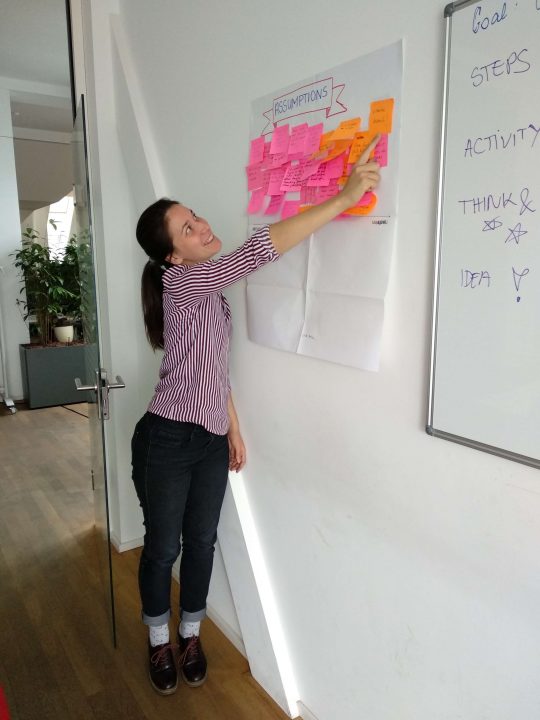 How to give design critique: researcher pointing to post-its