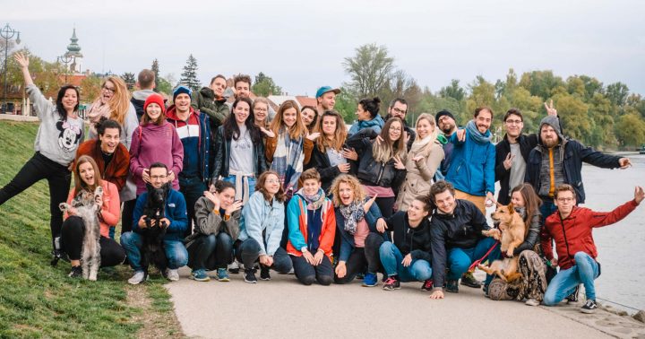 The 35-person UX studio team posing on the Danube shore in Szentendre in 2019