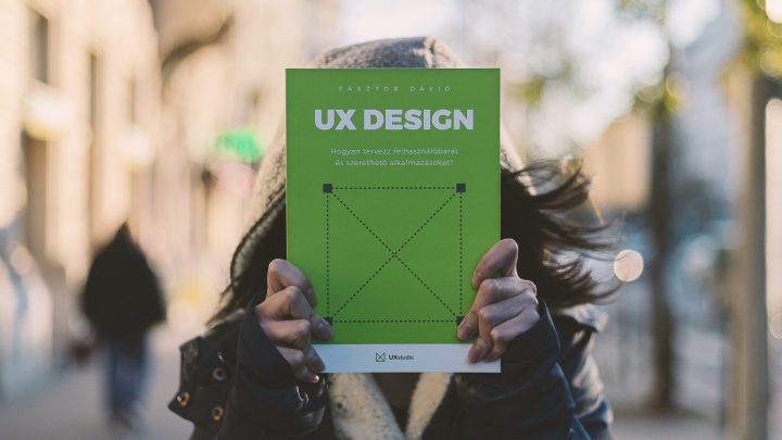 A person holding the UX Design book.